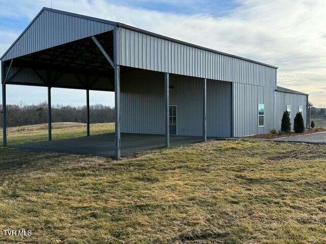 view of outbuilding featuring a lawn