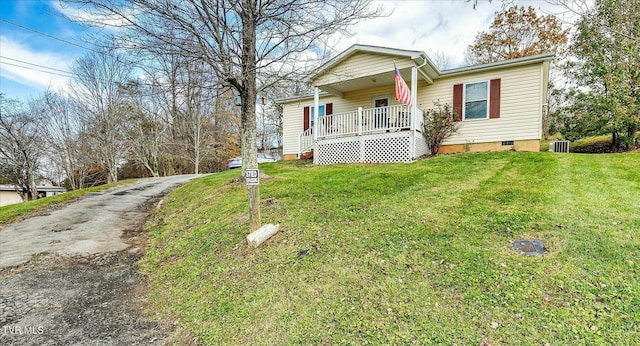 bungalow-style house featuring covered porch and a front yard