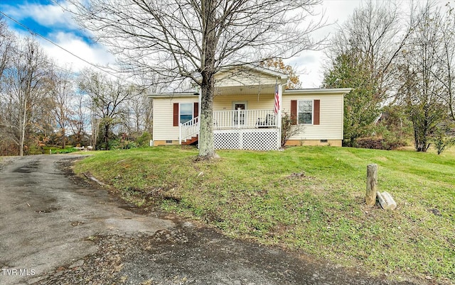 view of front of property with covered porch and a front yard