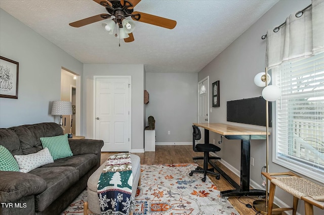 office area featuring hardwood / wood-style floors, ceiling fan, and a textured ceiling