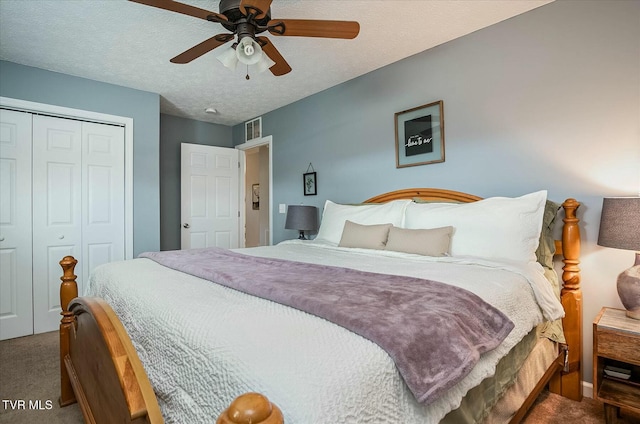 bedroom featuring carpet, a textured ceiling, a closet, and ceiling fan