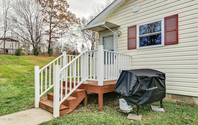 wooden deck with a yard and grilling area