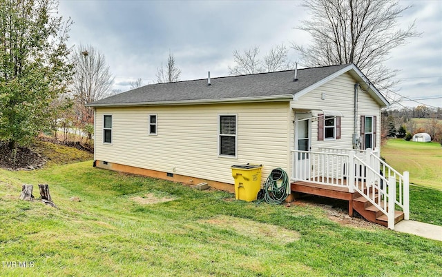 rear view of property with a lawn