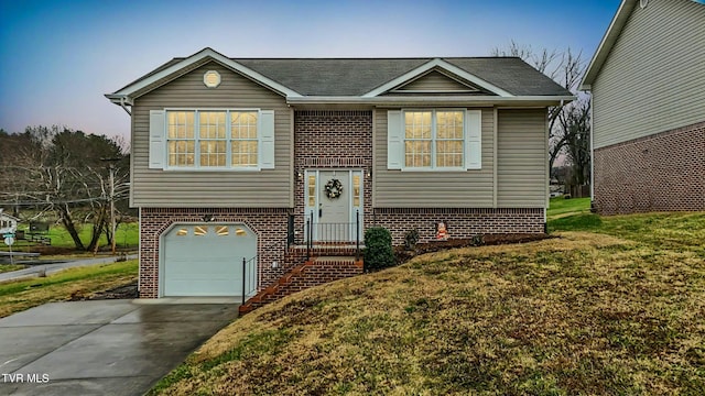 split foyer home with a garage and a front lawn