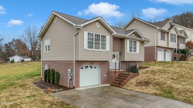 split foyer home featuring a garage and a front yard