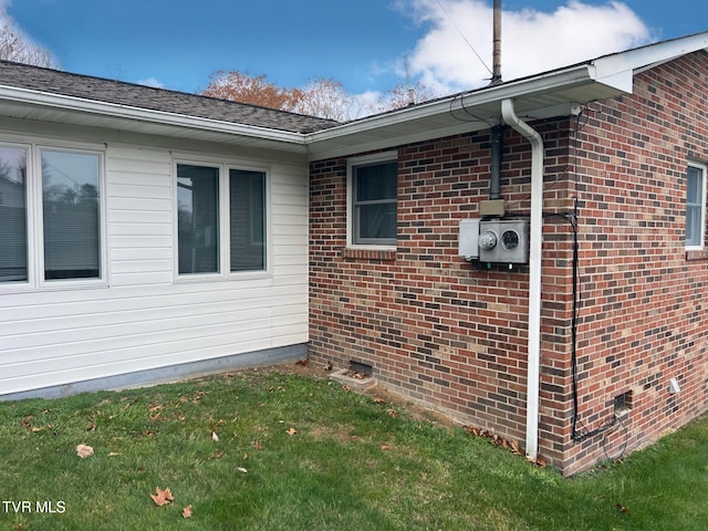 view of side of home with a yard