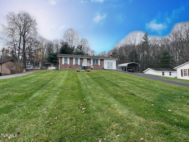 ranch-style house with a front yard and a carport