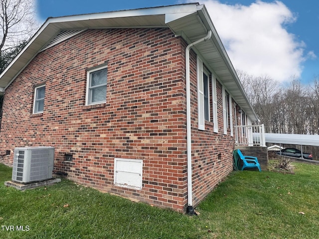 view of home's exterior with a yard and central AC