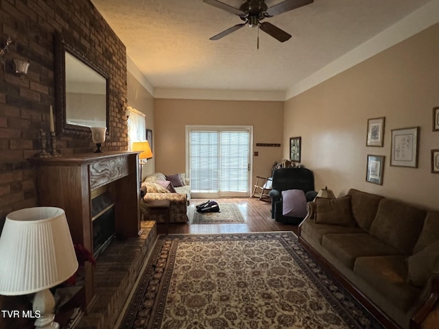 living room with ceiling fan, dark hardwood / wood-style flooring, and a fireplace