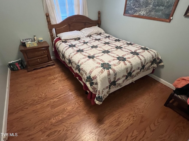 bedroom with hardwood / wood-style floors