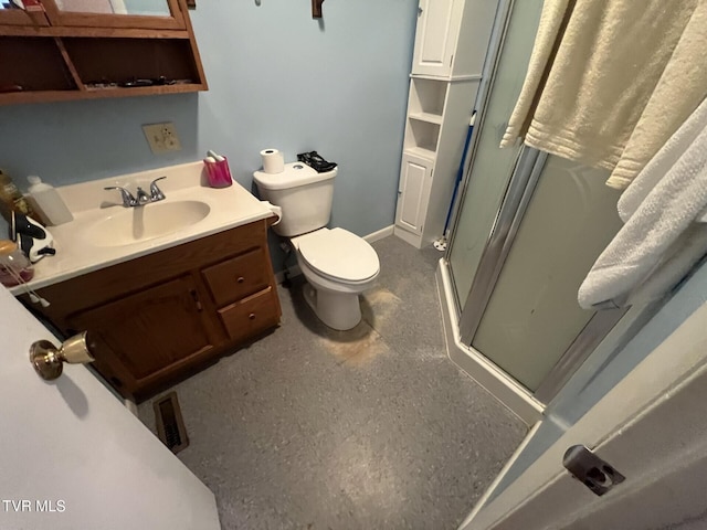 bathroom with vanity, toilet, and an enclosed shower