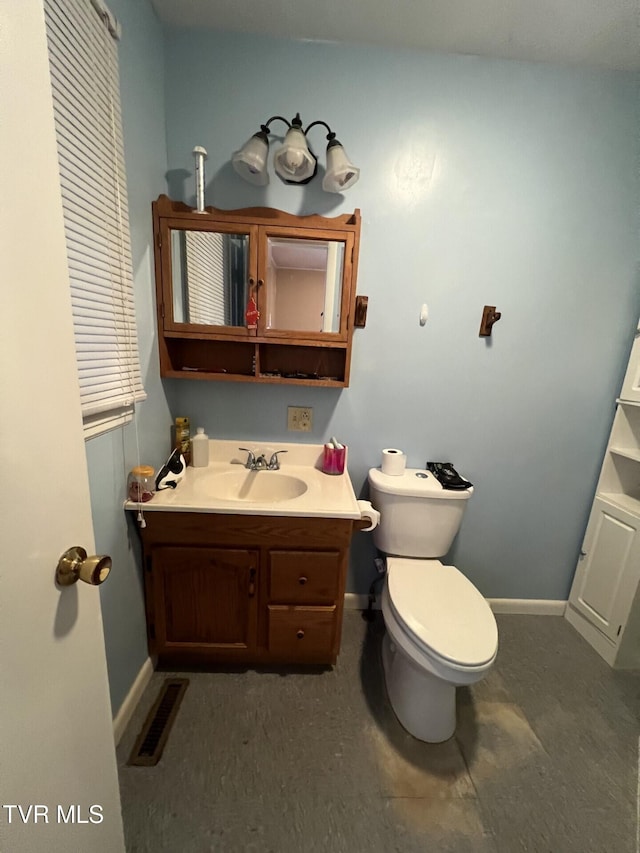 bathroom featuring vanity and toilet