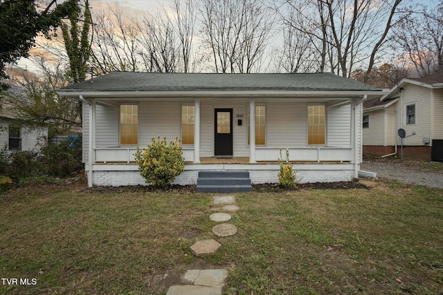 bungalow-style house with a lawn and a porch