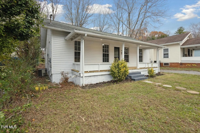 single story home featuring a front lawn and covered porch