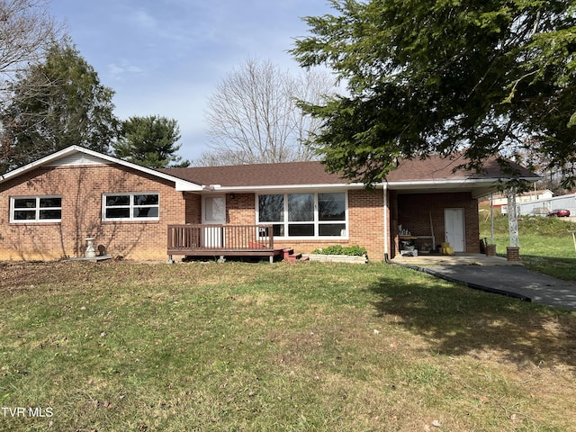 back of house with a yard, a carport, and a wooden deck