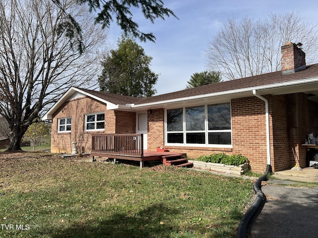 view of front of property with a front yard and a deck