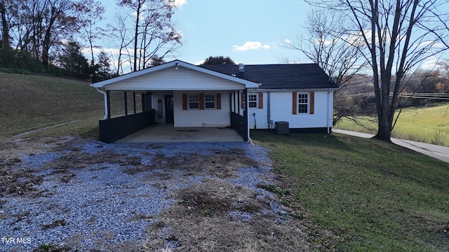 view of front of property with cooling unit and a front lawn