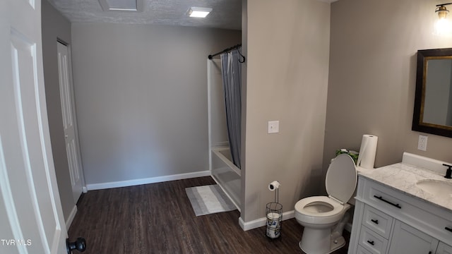 full bathroom featuring shower / bath combo, a textured ceiling, toilet, vanity, and hardwood / wood-style flooring