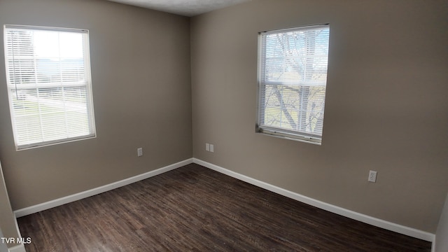 empty room featuring dark wood-type flooring