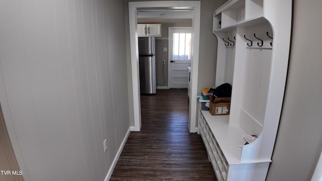 mudroom featuring dark hardwood / wood-style flooring and wood walls