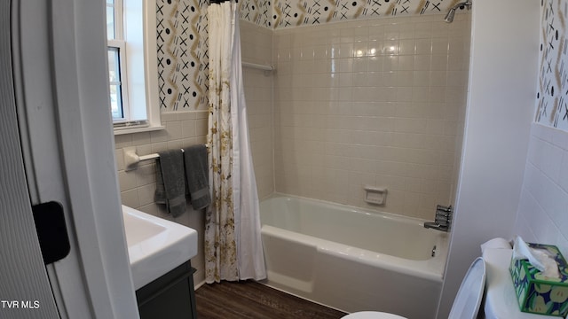 full bathroom featuring shower / tub combo, vanity, wood-type flooring, tile walls, and toilet