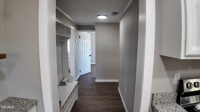 corridor featuring dark hardwood / wood-style floors and ornamental molding