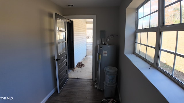 hall with dark hardwood / wood-style floors and electric water heater