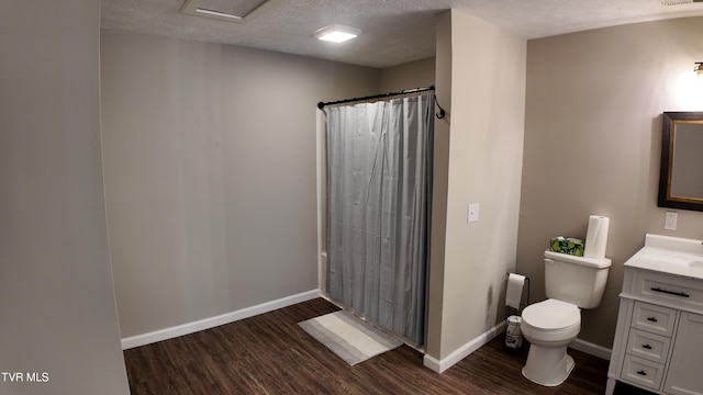 bathroom featuring walk in shower, wood-type flooring, a textured ceiling, toilet, and vanity