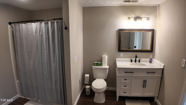 bathroom featuring hardwood / wood-style flooring, vanity, toilet, and a shower with curtain