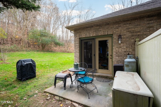 view of patio / terrace featuring a grill and central AC unit