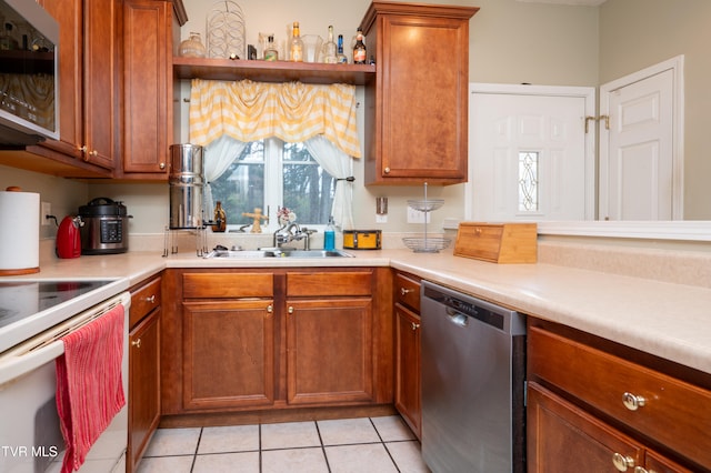 kitchen featuring sink, light tile patterned floors, and stainless steel appliances