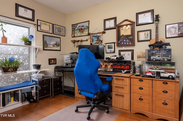 office featuring a textured ceiling and light wood-type flooring