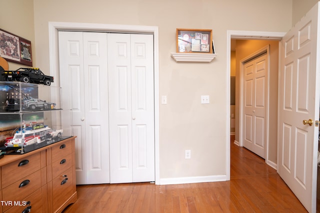 unfurnished bedroom featuring a closet and light hardwood / wood-style flooring