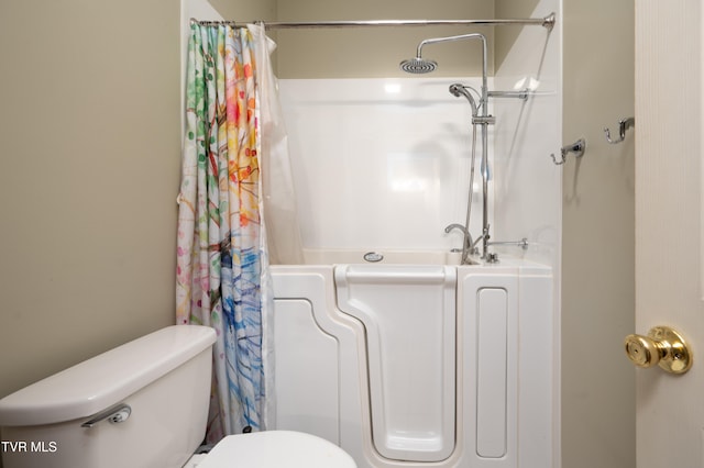 bathroom featuring toilet and shower with separate bathtub