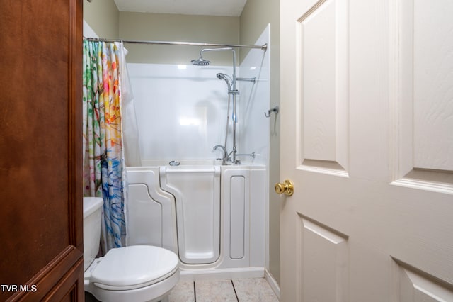 bathroom with toilet, a textured ceiling, tile patterned floors, and curtained shower