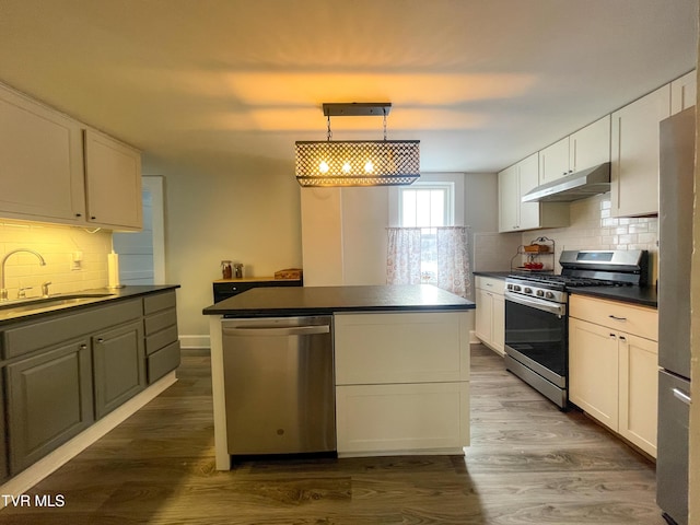 kitchen featuring white cabinets, appliances with stainless steel finishes, dark hardwood / wood-style flooring, and sink