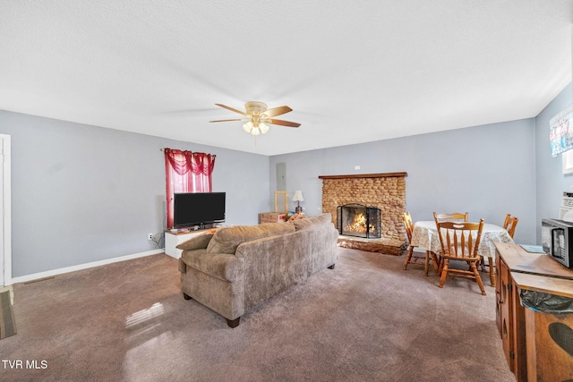 carpeted living room with ceiling fan and a brick fireplace