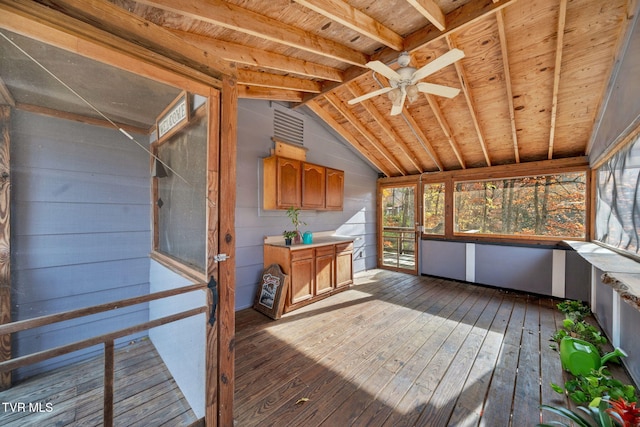 unfurnished sunroom featuring ceiling fan, wood ceiling, and lofted ceiling