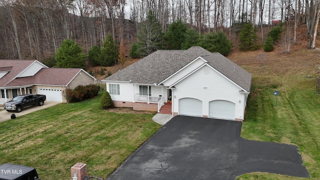 view of front of home featuring a garage, a front yard, and a porch