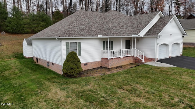 view of front of house featuring covered porch, a front lawn, and a garage