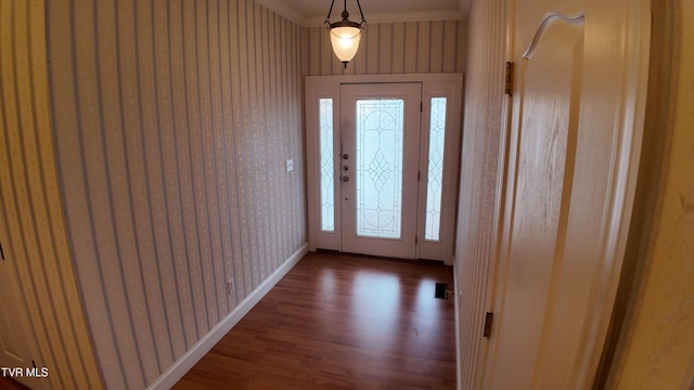 foyer featuring crown molding and wood-type flooring