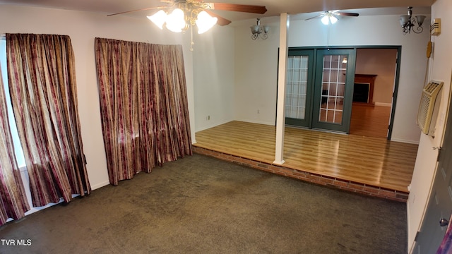 spare room featuring dark colored carpet and ceiling fan