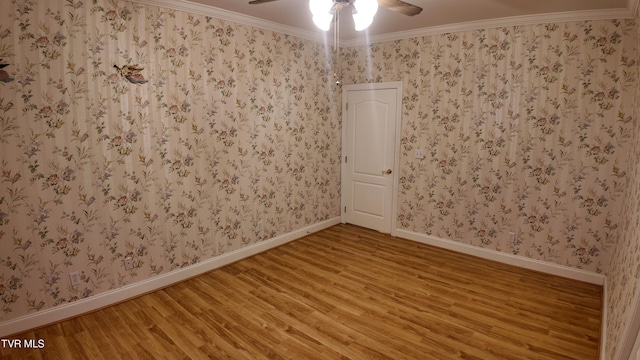 empty room with ceiling fan, ornamental molding, and hardwood / wood-style floors