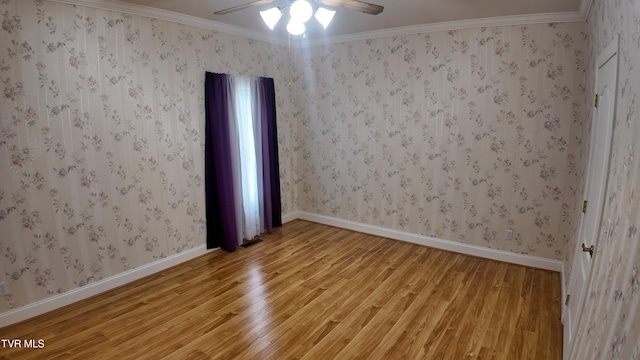 empty room featuring hardwood / wood-style flooring, ceiling fan, and ornamental molding