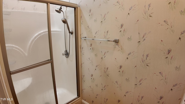 bathroom featuring a shower with door