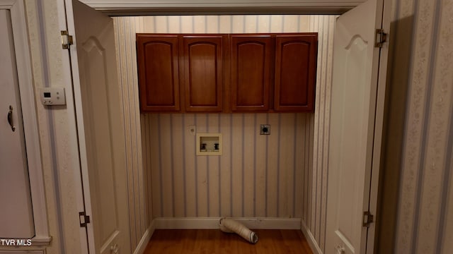 laundry area with hookup for a washing machine, wood-type flooring, cabinets, and hookup for an electric dryer