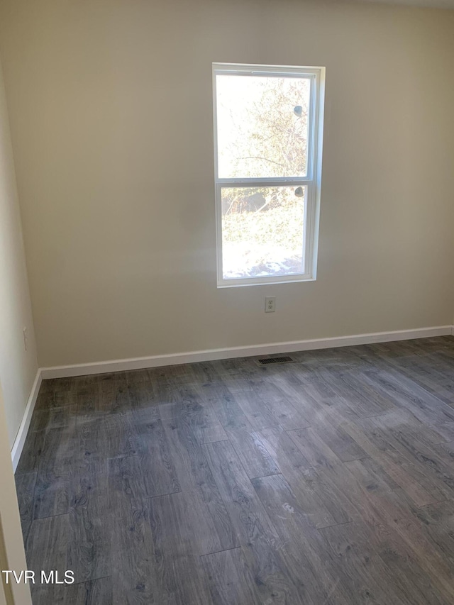 empty room with dark wood-type flooring