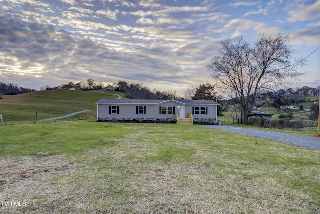 single story home with a yard and a rural view