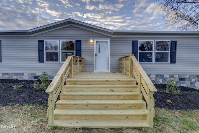 view of exterior entry featuring a deck