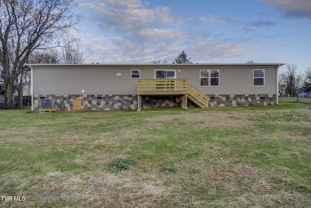 back of house with central air condition unit, a yard, and a deck